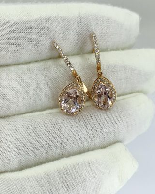 Set in soft 18ct rose gold and surrounded with diamonds. Morganite with its soft pinkish hue, is often associated with innocence, sweetness, romance and love. Morganite is believed to bring healing, compassion and promise to those who wear it.